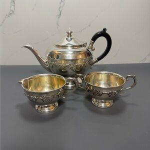 Elegant Silver Tea Set with Black Handle
